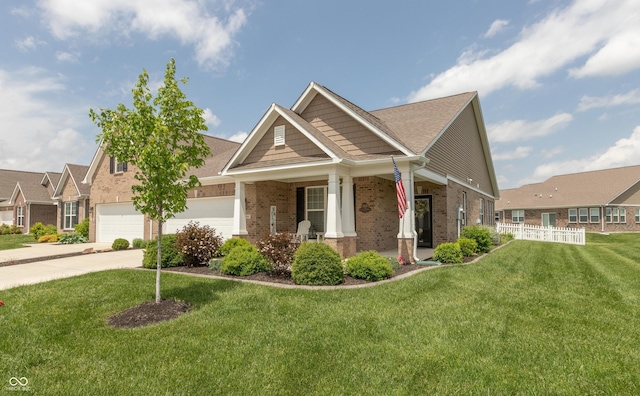 9166 Lieven St, Avon, IN 46123 - view of front of home featuring brick siding, a porch, a garage, driveway, and a front lawn