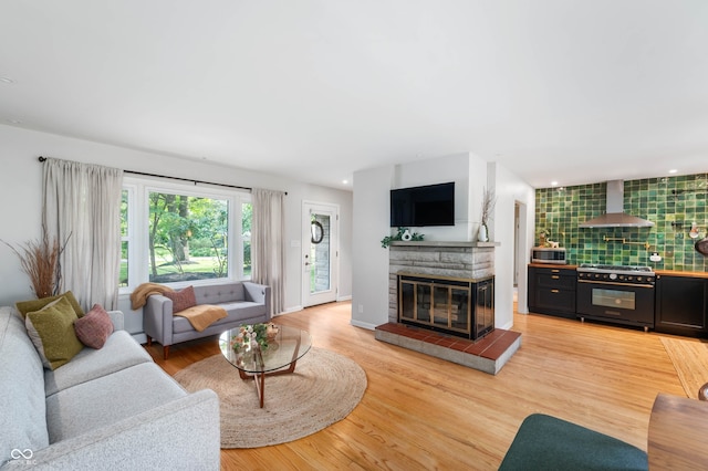 2120 Wynnedale Rd, Indianapolis, IN 46228 - living room featuring a tile fireplace, light wood-style floors, and recessed lighting