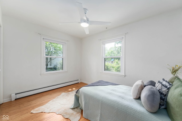 2120 Wynnedale Rd, Indianapolis, IN 46228 - bedroom featuring a baseboard radiator, wood finished floors, and ceiling fan