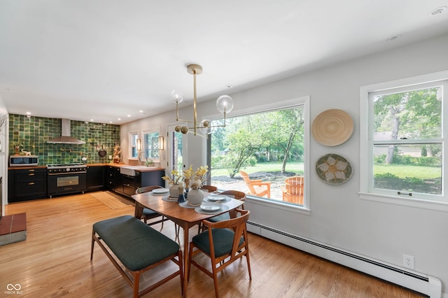 2120 Wynnedale Rd, Indianapolis, IN 46228 - dining area featuring a baseboard radiator, plenty of natural light, light wood-style floors, recessed lighting, and a chandelier