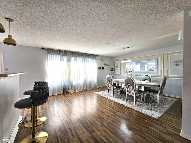 10836 Zimmerman Ln, Indianapolis, IN 46231 - dining room with wood finished floors, a textured ceiling, and baseboards