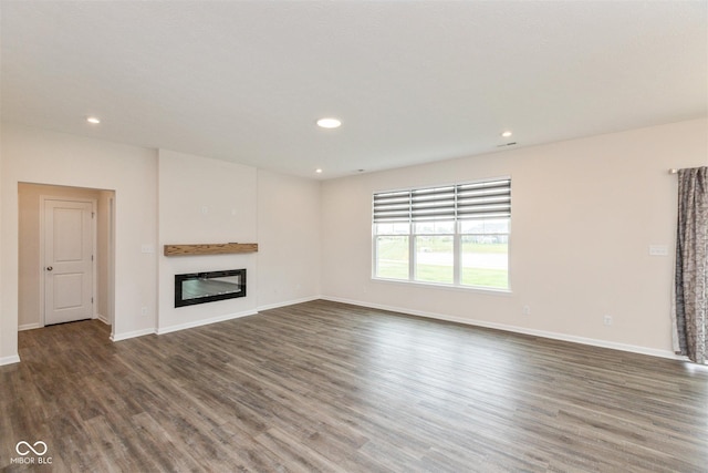 3980 Railhead Ave, Westfield, IN 46074 - unfurnished living room featuring wood finished floors, baseboards, a glass covered fireplace, and recessed lighting