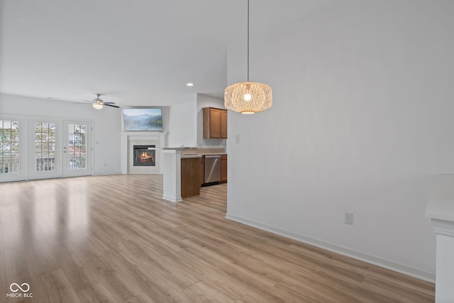4261 Washington Blvd, Plainfield, IN 46168 - unfurnished living room with a glass covered fireplace, a ceiling fan, light wood finished floors, baseboards, and recessed lighting