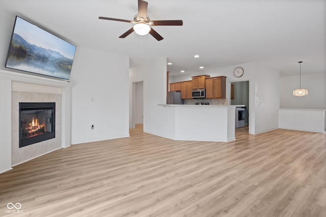 4261 Washington Blvd, Plainfield, IN 46168 - unfurnished living room with light wood-style floors, ceiling fan, a fireplace, and recessed lighting