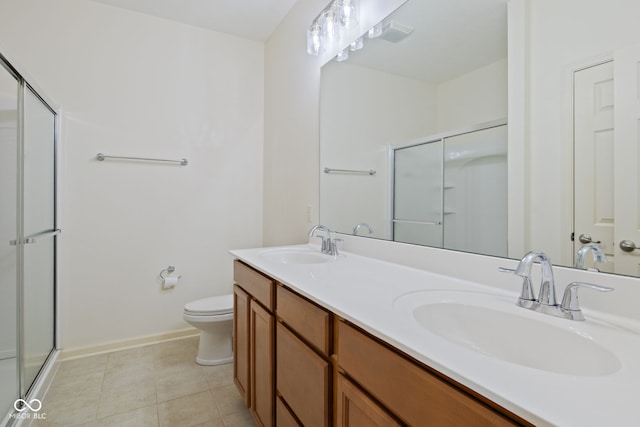 4261 Washington Blvd, Plainfield, IN 46168 - full bathroom with a shower stall, double vanity, toilet, tile patterned floors, and baseboards
