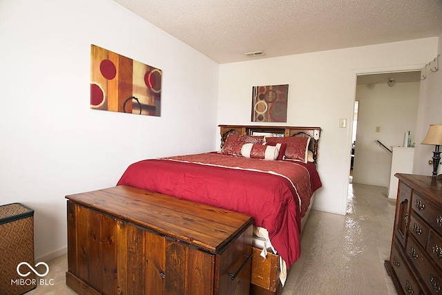 7737 Wolfgang Pl, Indianapolis, IN 46239 - bedroom featuring concrete floors and a textured ceiling