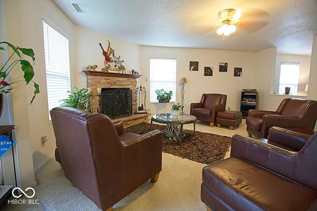 7737 Wolfgang Pl, Indianapolis, IN 46239 - living area with carpet floors, a textured ceiling, a stone fireplace, healthy amount of natural light, and a ceiling fan