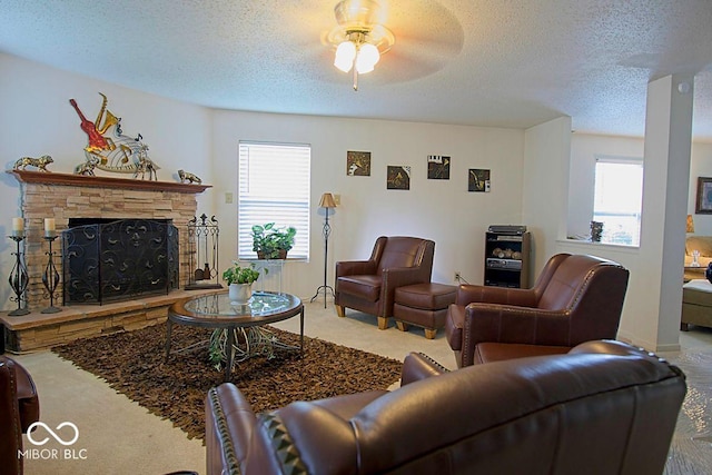 7737 Wolfgang Pl, Indianapolis, IN 46239 - living room featuring a ceiling fan, a textured ceiling, a fireplace, and carpet flooring