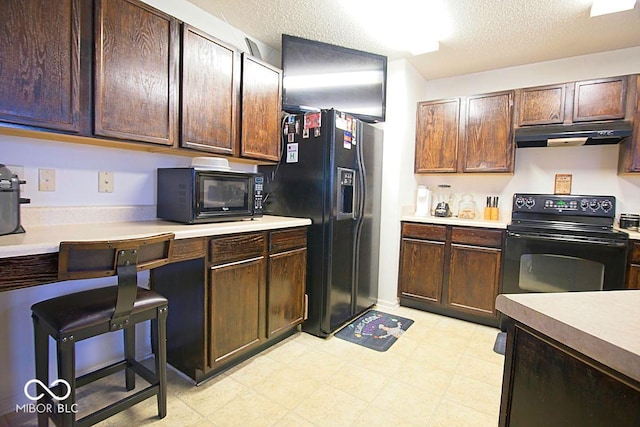 7737 Wolfgang Pl, Indianapolis, IN 46239 - kitchen with black appliances, under cabinet range hood, light countertops, light flooring, and a textured ceiling