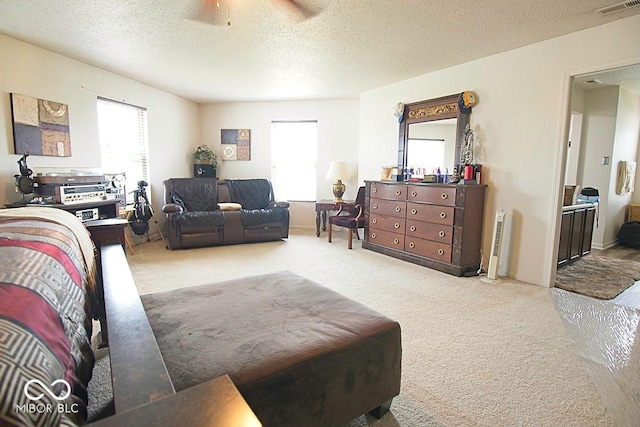 7737 Wolfgang Pl, Indianapolis, IN 46239 - carpeted bedroom with multiple windows, a textured ceiling, and ceiling fan