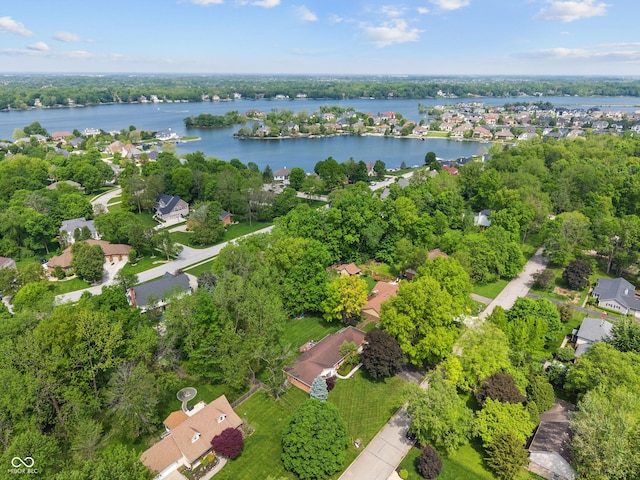 aerial view of property and surrounding area with a nearby body of water and nearby suburban area