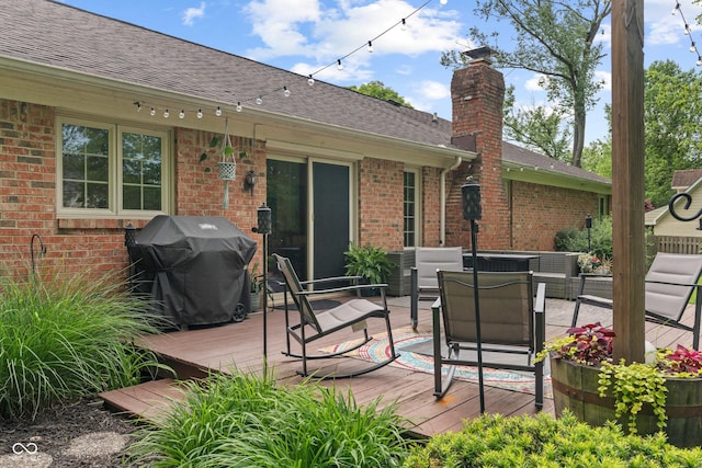 deck with an outdoor living space and grilling area