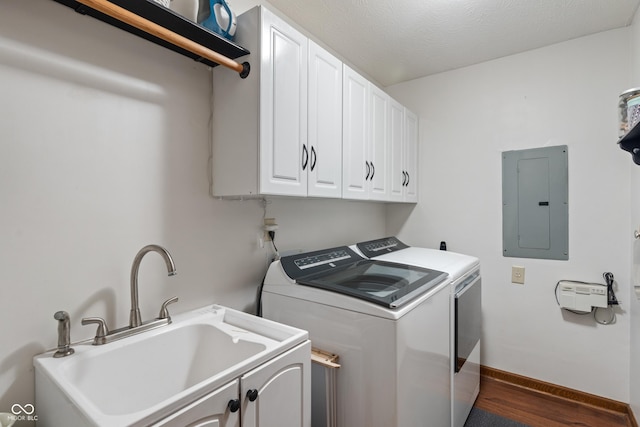 laundry area with cabinet space, electric panel, independent washer and dryer, dark wood-style flooring, and baseboards