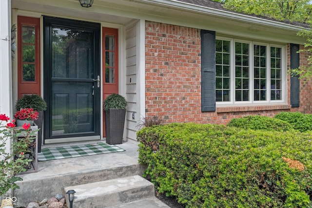 property entrance with brick siding