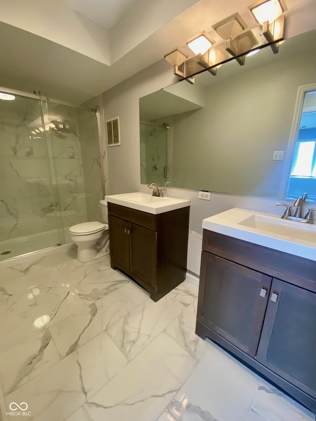 1150 Canterbury Ct Apt D, Indianapolis, IN 46260 - bathroom featuring a marble finish shower, two vanities, marble finish floors, and toilet