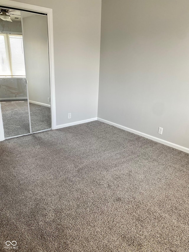 1150 Canterbury Ct Apt D, Indianapolis, IN 46260 - unfurnished bedroom featuring carpet floors, baseboards, and a closet