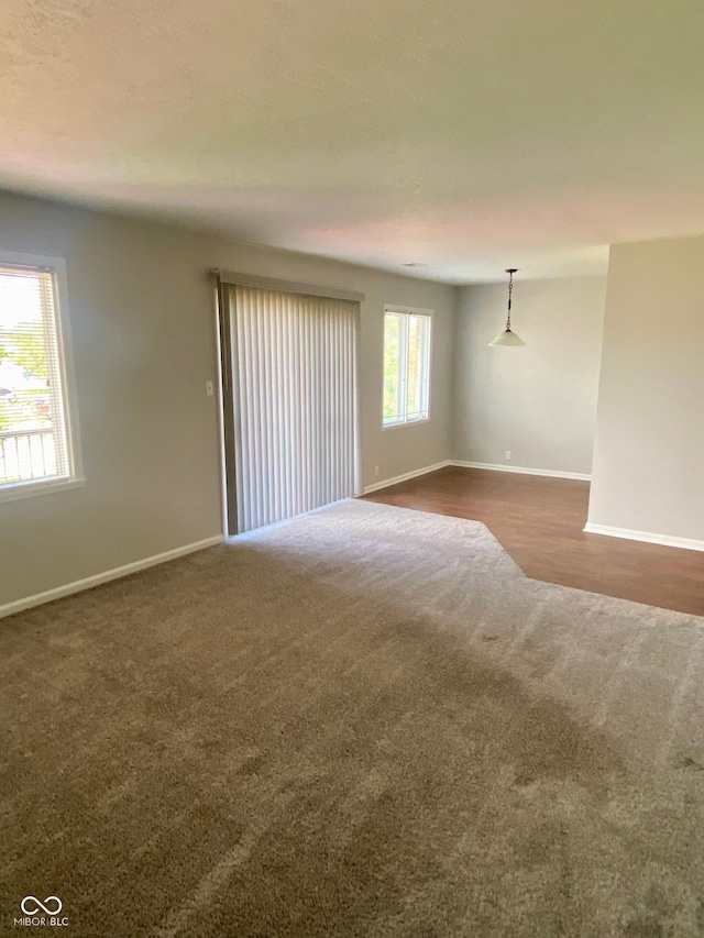 1150 Canterbury Ct Apt D, Indianapolis, IN 46260 - spare room with dark carpet and baseboards