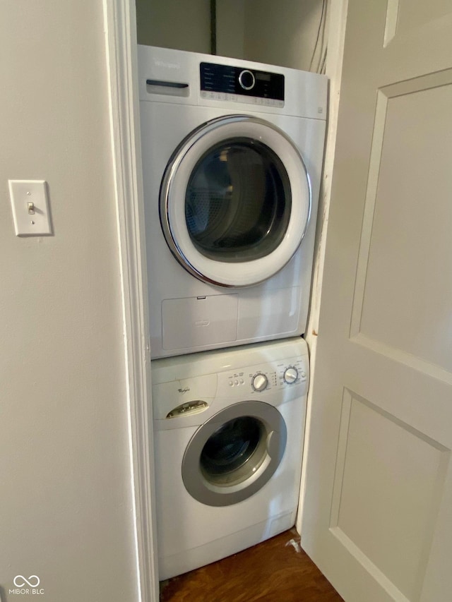 1150 Canterbury Ct Apt D, Indianapolis, IN 46260 - washroom featuring stacked washing machine and dryer and dark wood finished floors