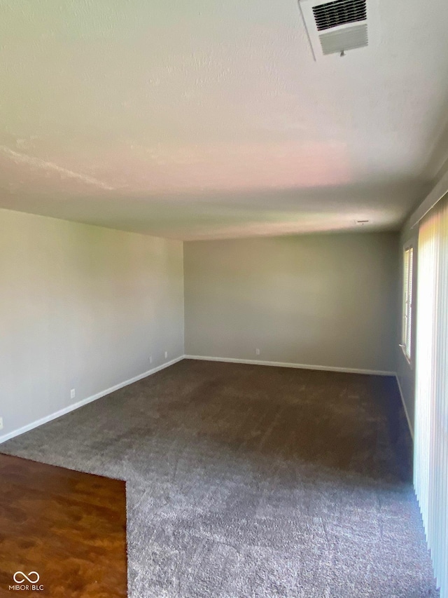 1150 Canterbury Ct Apt D, Indianapolis, IN 46260 - spare room with dark carpet and baseboards