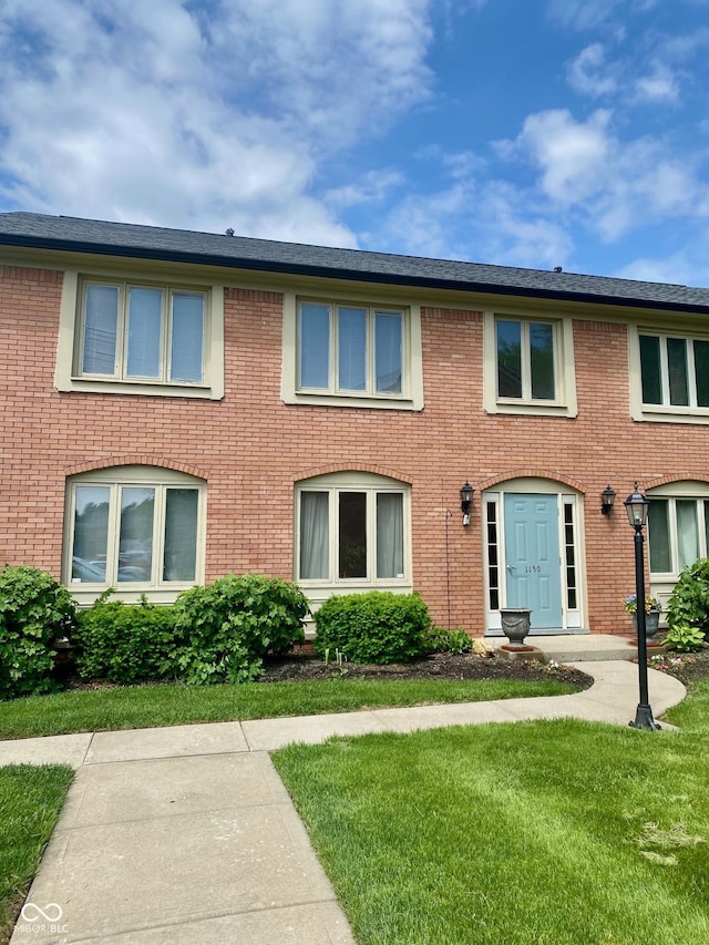 1150 Canterbury Ct Apt D, Indianapolis, IN 46260 - colonial house with a front lawn and brick siding