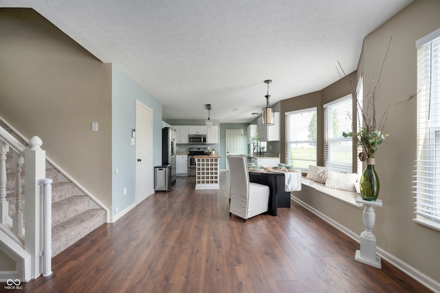12331 Chiseled Stone Dr, Fishers, IN 46037 - living room with dark wood finished floors, stairs, and a textured ceiling