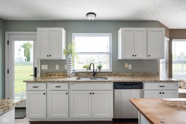 12331 Chiseled Stone Dr, Fishers, IN 46037 - kitchen with stainless steel dishwasher, white cabinets, and wooden counters