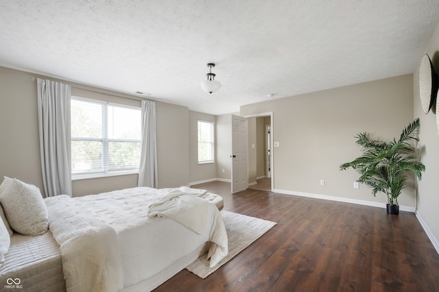 12331 Chiseled Stone Dr, Fishers, IN 46037 - bedroom featuring dark wood-style flooring and a textured ceiling