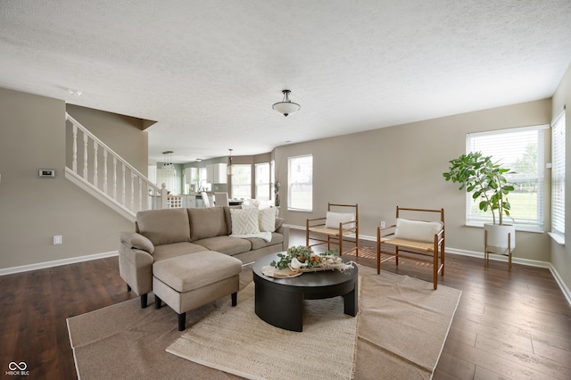 12331 Chiseled Stone Dr, Fishers, IN 46037 - living room with a textured ceiling, stairs, and dark wood-style floors