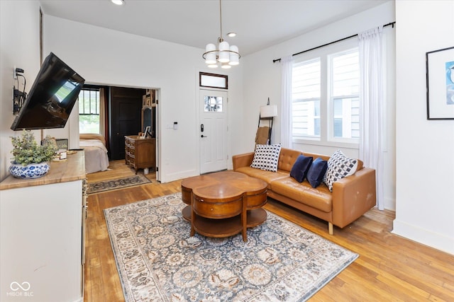 1730 Hoyt Ave, Indianapolis, IN 46203 - living room featuring light wood-style flooring, a chandelier, recessed lighting, and baseboards