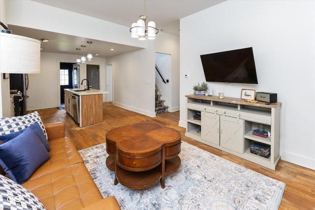 1730 Hoyt Ave, Indianapolis, IN 46203 - living area featuring a chandelier, wood finished floors, stairway, and baseboards