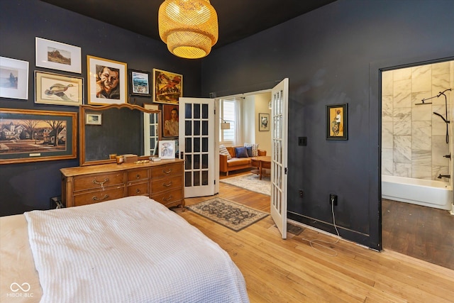 1730 Hoyt Ave, Indianapolis, IN 46203 - bedroom with french doors, light wood-style flooring, and a high ceiling