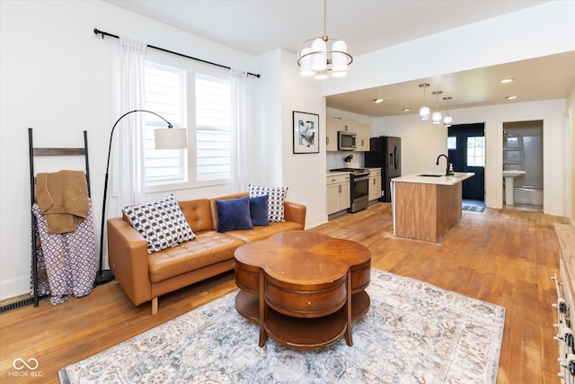 1730 Hoyt Ave, Indianapolis, IN 46203 - living area with a chandelier, light wood-style flooring, and recessed lighting