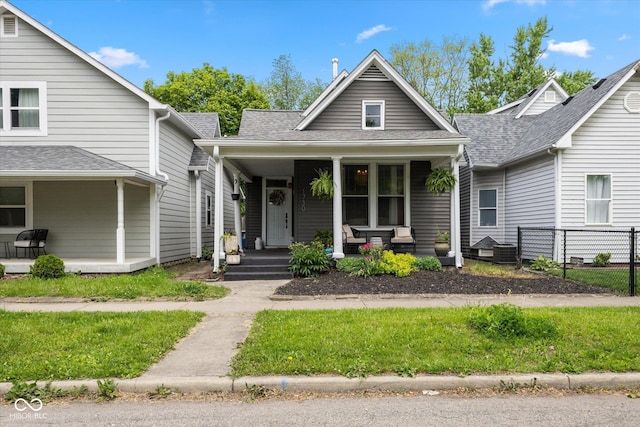 1730 Hoyt Ave, Indianapolis, IN 46203 - view of front of house with a porch, fence, and a shingled roof