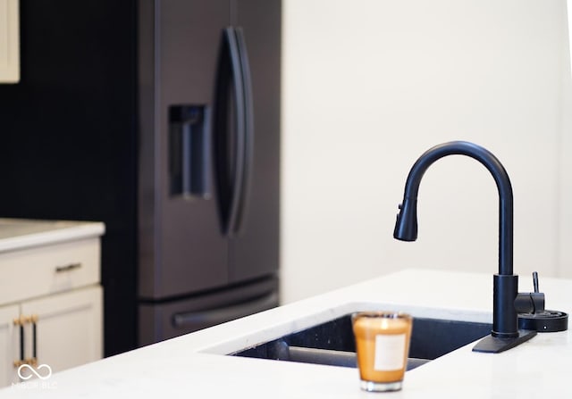 1730 Hoyt Ave, Indianapolis, IN 46203 - kitchen view of a sink, black refrigerator with ice dispenser, and light countertops