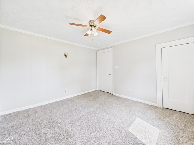 903 W 22nd St, Anderson, IN 46016 - spare room featuring ceiling fan, carpet, crown molding, and baseboards
