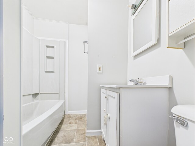 903 W 22nd St, Anderson, IN 46016 - bathroom with vanity, baseboards, toilet, and stone finish flooring