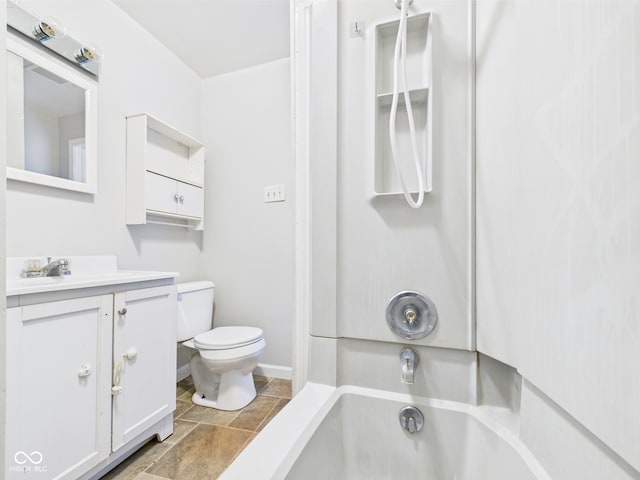 903 W 22nd St, Anderson, IN 46016 - bathroom with stone finish floors, toilet, vanity, shower / bath combination, and baseboards