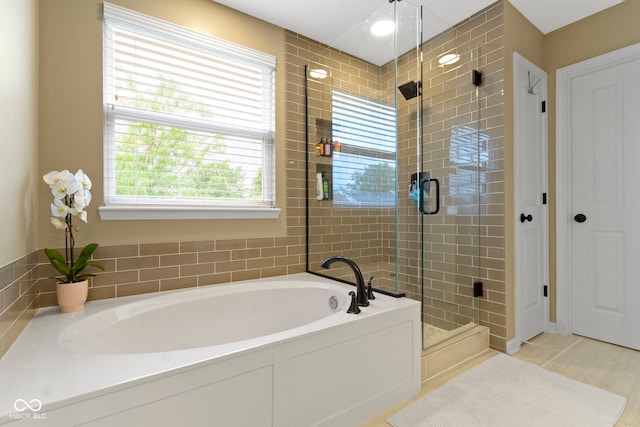 bathroom with a garden tub and a shower stall