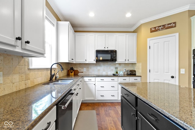 kitchen featuring black appliances, a sink, dark cabinetry, white cabinetry, and ornamental molding