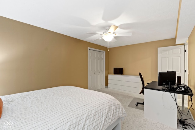 carpeted bedroom with a closet, a ceiling fan, and a desk