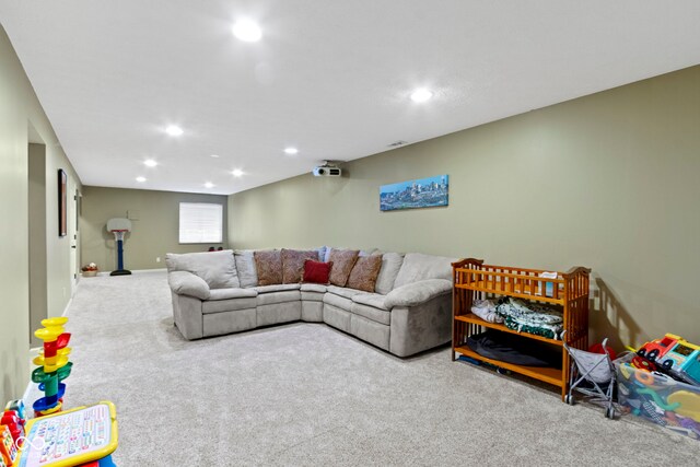 carpeted living area featuring recessed lighting and baseboards