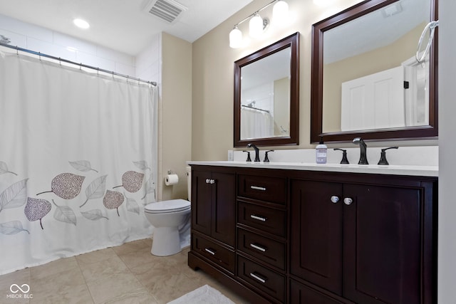 bathroom with toilet, double vanity, and a shower with curtain