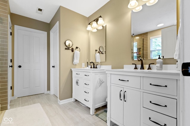 full bath with two vanities, baseboards, and a shower