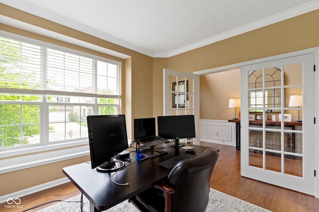 office space featuring crown molding, wood finished floors, and wainscoting