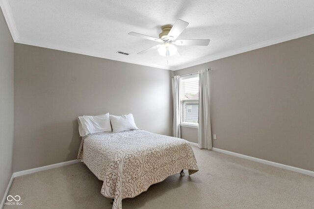 bedroom featuring crown molding, light colored carpet, baseboards, and a ceiling fan