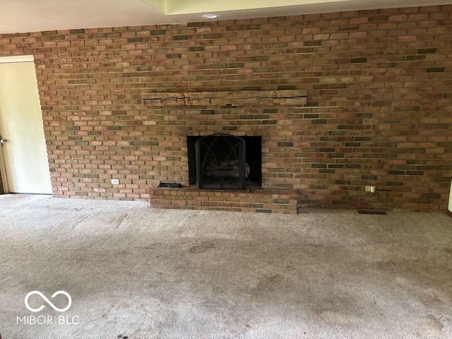 310 S Shady Ln, Muncie, IN 47304 - unfurnished living room with carpet, brick wall, and a brick fireplace