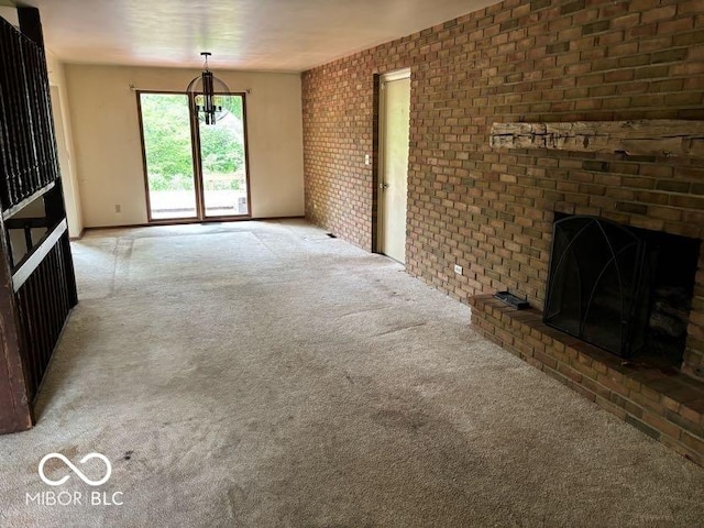 310 S Shady Ln, Muncie, IN 47304 - unfurnished living room with carpet, brick wall, a fireplace, and a chandelier