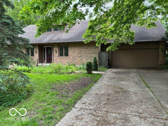 310 S Shady Ln, Muncie, IN 47304 - view of front of house with brick siding, a garage, and a shingled roof