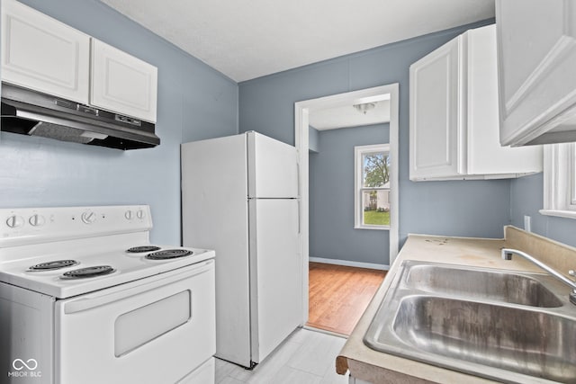 703 Kappes St, Indianapolis, IN 46221 - kitchen with white appliances, under cabinet range hood, a sink, white cabinetry, and light countertops