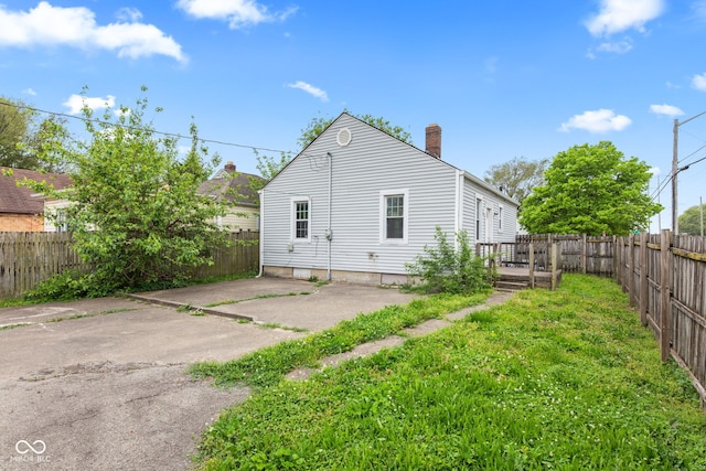 703 Kappes St, Indianapolis, IN 46221 - back of house featuring a chimney and a patio area